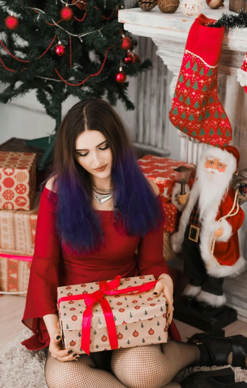 a woman sitting in front of a christmas tree holding a present, a colorized photo, by Julia Pishtar, pexels contest winner, tachisme, long violet hair, sitting on santa, an attractive, gif