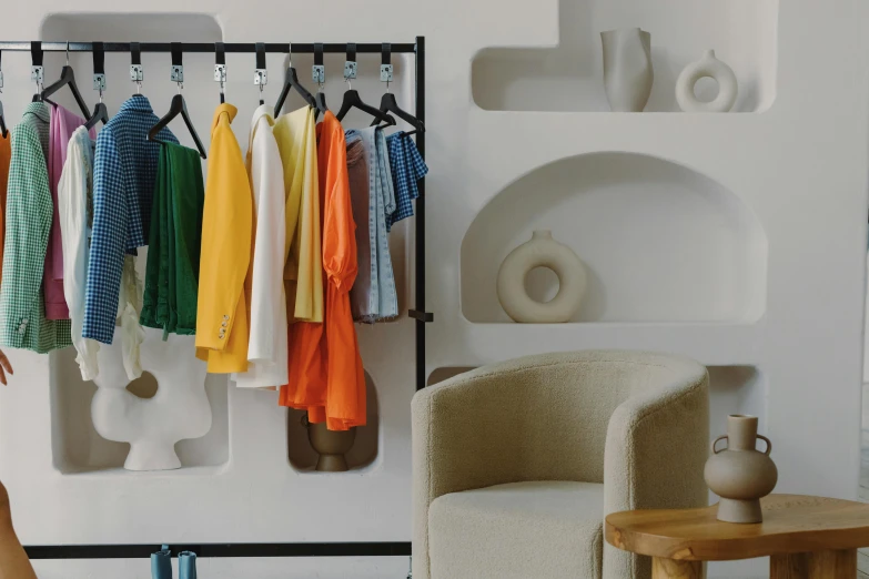 a living room filled with furniture and colorful clothes, inspired by Francesco Furini, cycladic sculptural style, storefront, in style of lam manh, ecommerce photograph