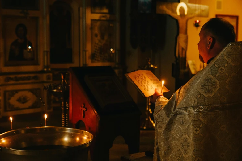 a priest reading a book in a church, by Alexander Fedosav, pexels, holding a torch, orthodox icons, [ cinematic, multiple stories