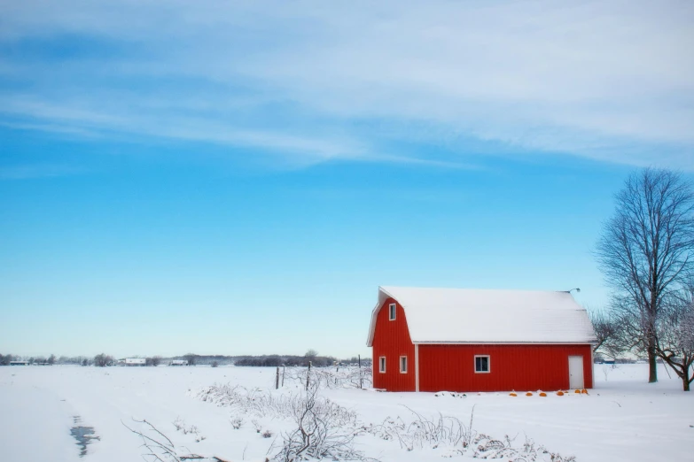 a red barn sitting on top of a snow covered field, pexels contest winner, big blue sky, white building, fargo, nordic