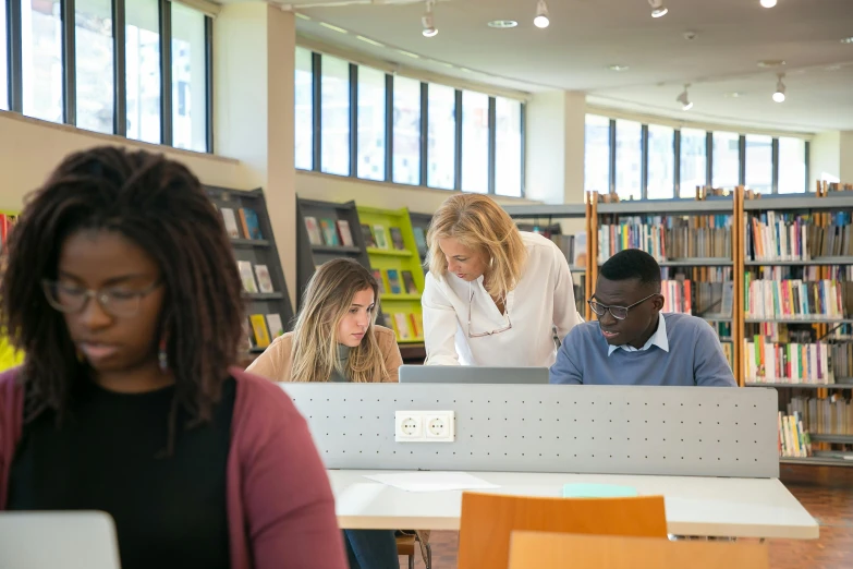 a group of people working on laptops in a library, by Carey Morris, eal, studying in a brightly lit room, profile image, thumbnail