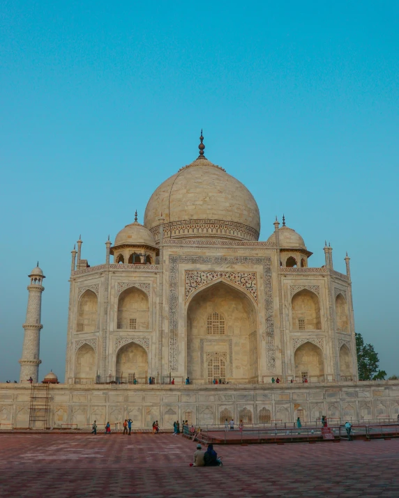 a group of people standing in front of a building, a marble sculpture, inspired by Steve McCurry, pexels contest winner, taj mahal made of cheese, thumbnail, lgbtq, evening time