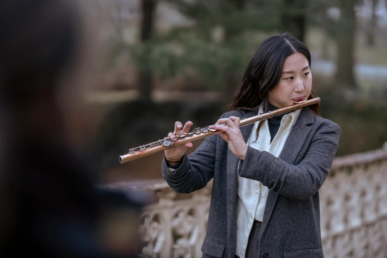 a woman playing a flute on a bridge, an album cover, inspired by Li Di, pexels contest winner, baroque, yanjun chengt, performance, press shot, brown