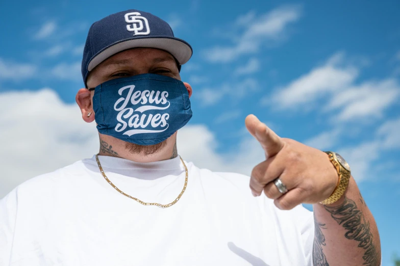 a man wearing a face mask that says jesus saves, inspired by Jason Felix, graffiti, god - rays, hypebeast, promo photo, california