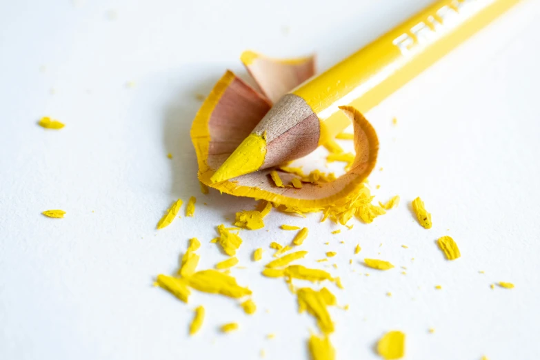 a yellow pencil with a bite taken out of it, by Gavin Hamilton, pexels contest winner, hyperrealism, yellow ochre, petals, full product shot, crushed