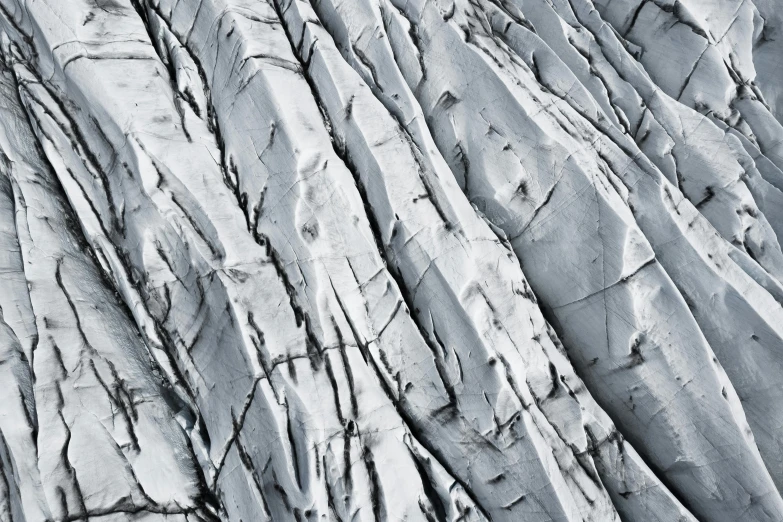 a black and white photo of a rock face, unsplash, abstract expressionism, blue glacier, circuitry. 8k 3d geology, iceland photography, rock roof