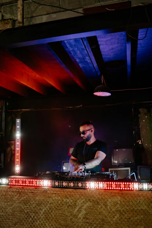 a man that is standing in front of a stage, in a nightclub, profile image