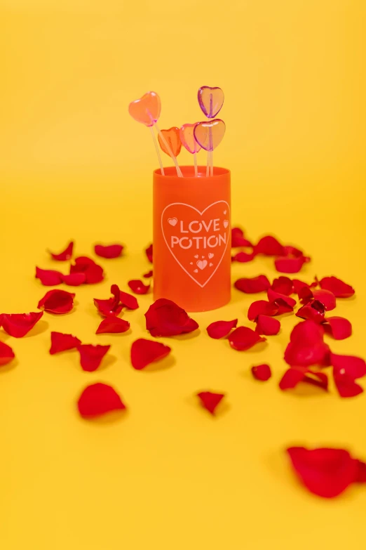a candle and rose petals on a yellow background, by Lucette Barker, featured on instagram, pop art, glow sticks, made out of sweets, pvc poseable, red hearts
