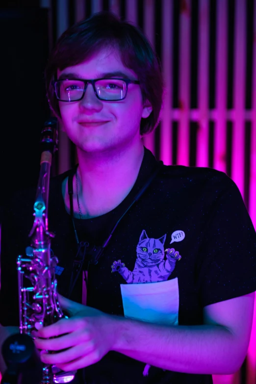 a close up of a person holding a saxophone, featured on reddit, twitch streamer / gamer ludwig, stood in a lab, cute slightly nerdy smile, taken in night club