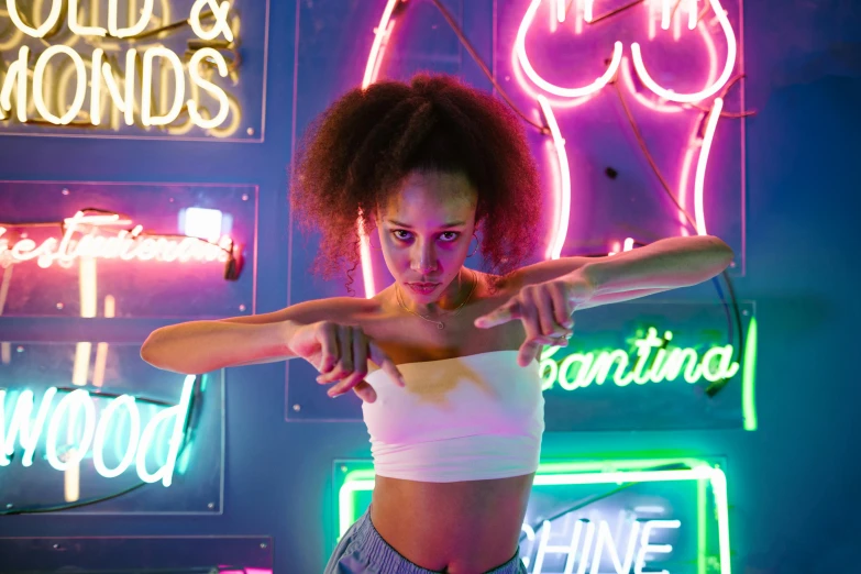 a woman holding a baseball bat in front of neon signs, inspired by David LaChapelle, pexels contest winner, nathalie emmanuel, wearing a crop top, arms stretched out, pink and blue lighting