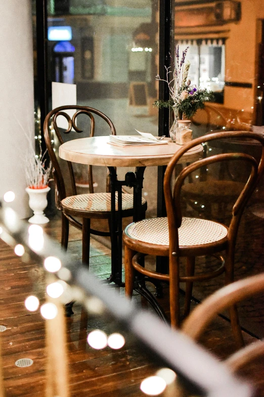 a couple of wooden chairs sitting next to a table, inspired by Albert Paris Gütersloh, unsplash, festive atmosphere, multiple stories, lots de details, brown