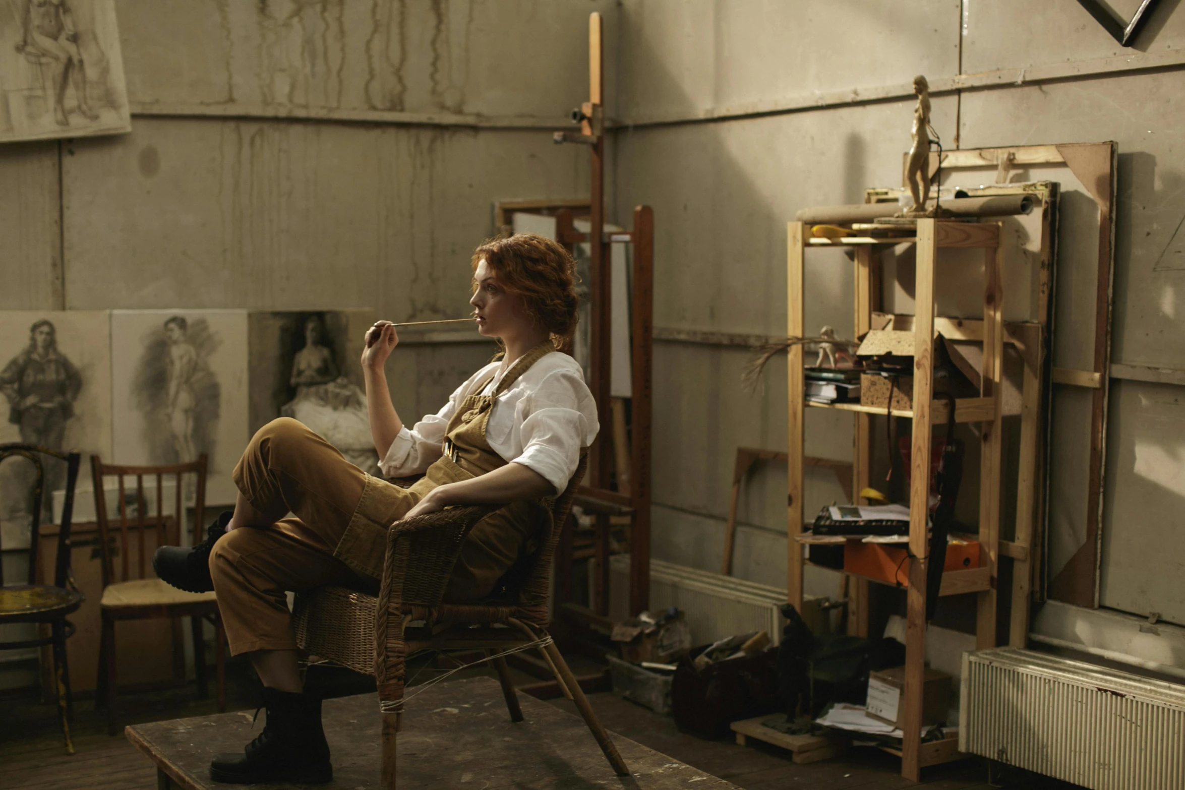 a woman sitting in a chair in a room, a photorealistic painting, inspired by Jules Bastien-Lepage, unsplash, australian tonalism, in his basement studio, still from a wes anderson movie, in a workshop, hannah af klint