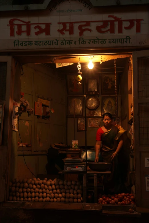 a man that is standing in front of a store, bengal school of art, dimly-lit cozy tavern, half - electric woman, potato, low lighting