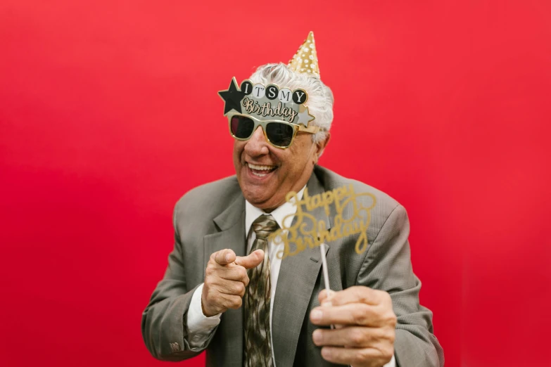 a man wearing a party hat and sunglasses, pexels, elderly, photo booth, happy birthday, wearing a crown and suit