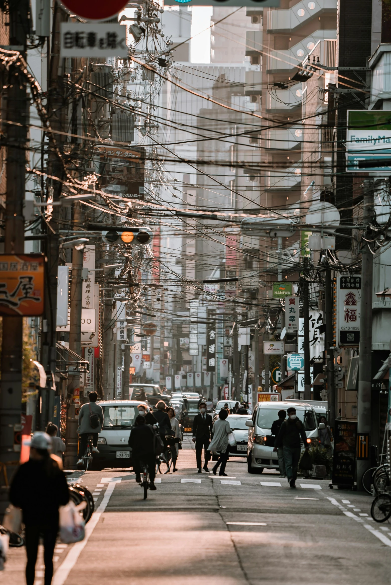 a group of people walking down a street next to tall buildings, a picture, pexels contest winner, electrical wires, japanese village, full of things, overlay