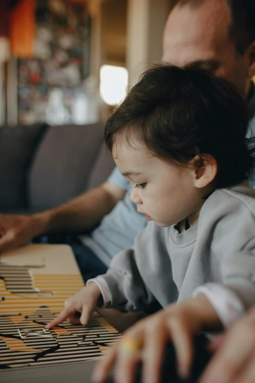 a little boy sitting in front of a laptop computer, pexels contest winner, xylophone, fatherly, gif, kai carpenter