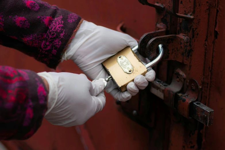 a person in white gloves holding a padlock, gilding, on location, rhys lee, professional work