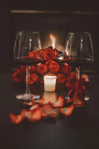 a candle and some wine glasses on a table, pexels contest winner, romanticism, red roses, red and brown color scheme, intense flirting, ivy's