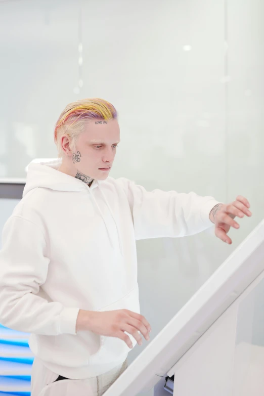 a man that is standing in front of a computer, inspired by Yanjun Cheng, trending on reddit, analytical art, albino hair, white wall coloured workshop, futuristic techwear, pastel coloring