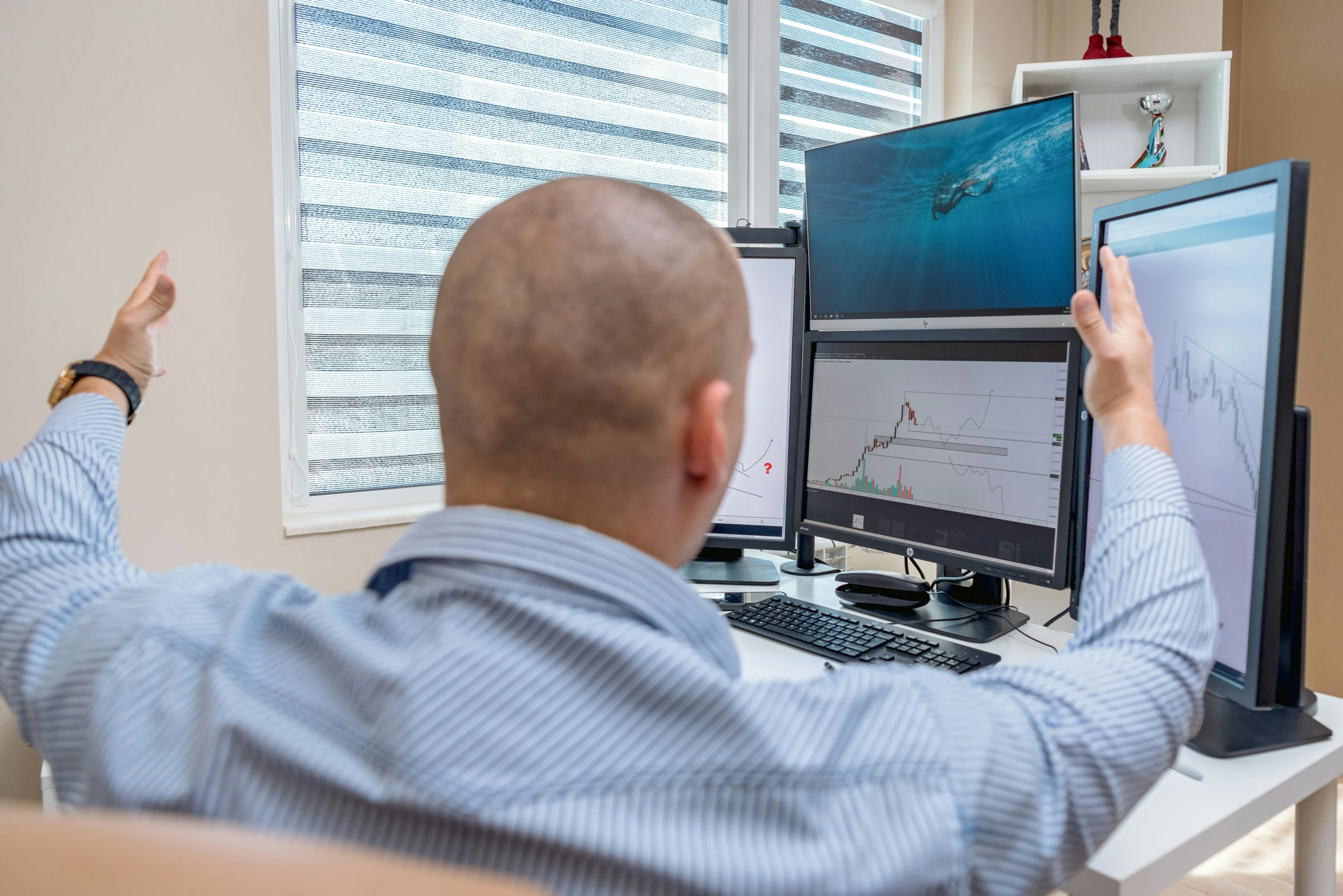 a man sitting at a desk in front of two computer monitors, a picture, by Adam Marczyński, fish in the background, avatar image, medical photography, manly
