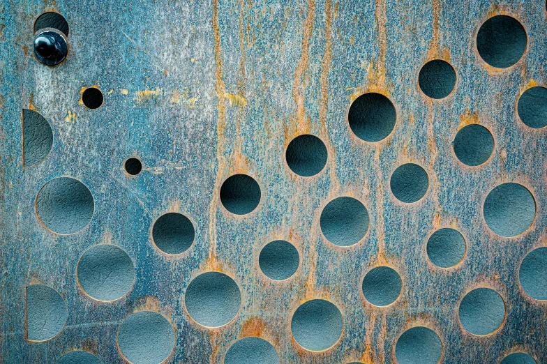 a rusted metal surface with holes in it, an album cover, inspired by Max Ernst, unsplash, light blues, round shapes, wood print, polkadots