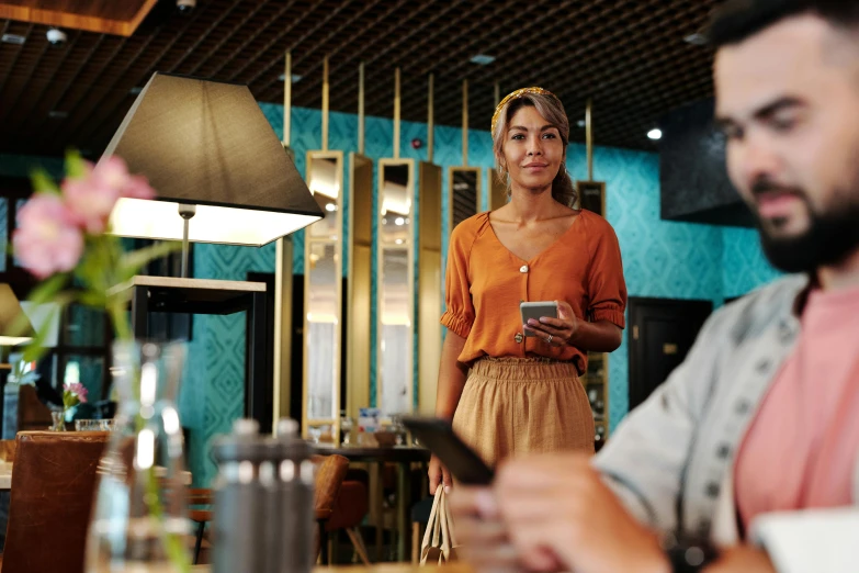 a man and a woman sitting at a table in a restaurant, trending on pexels, happening, goddess checking her phone, walking down, avatar image, worksafe. cinematic