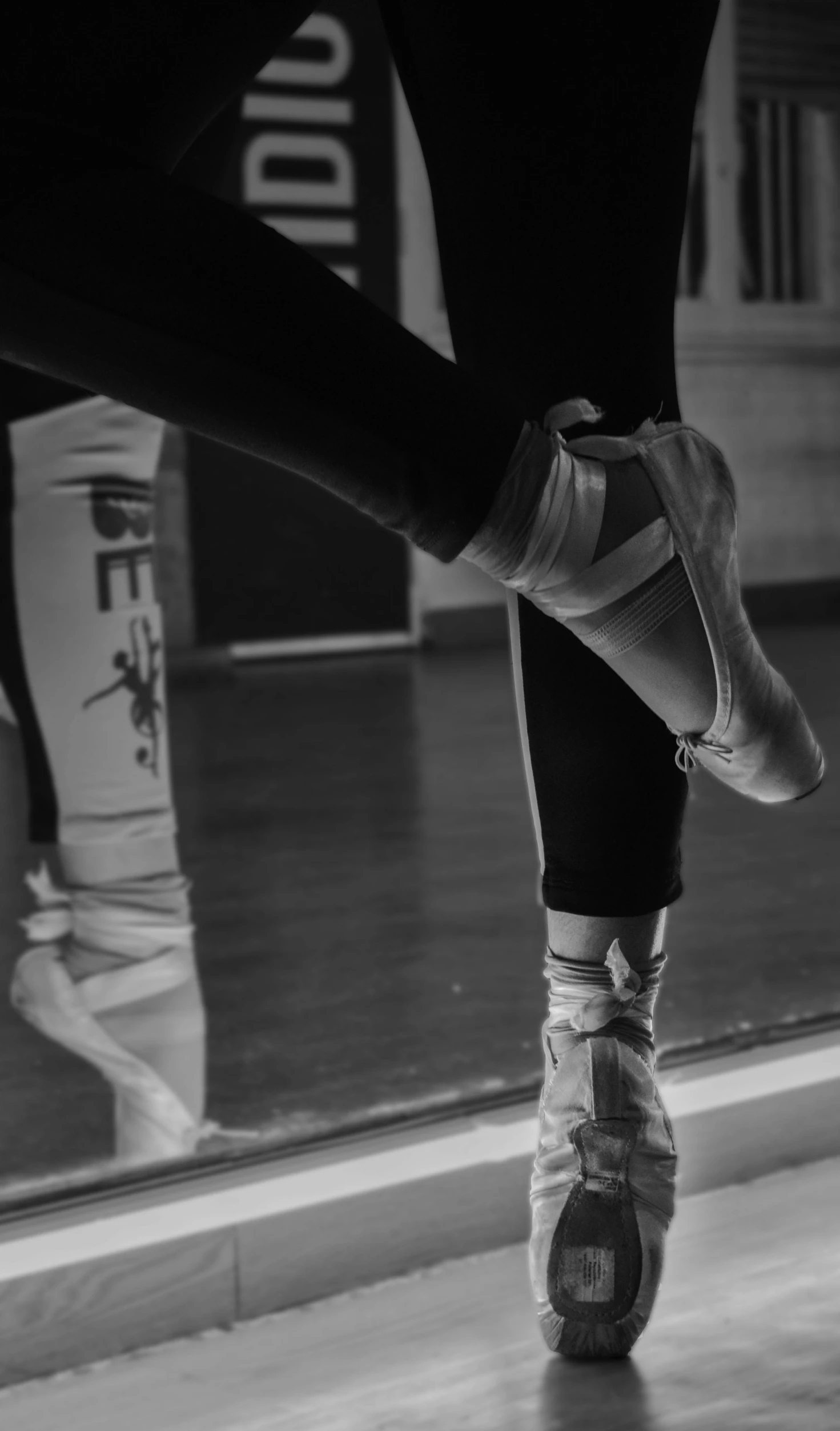 a black and white photo of a person wearing ballet shoes, pexels, mirrored, sports photo, thumbnail, uploaded