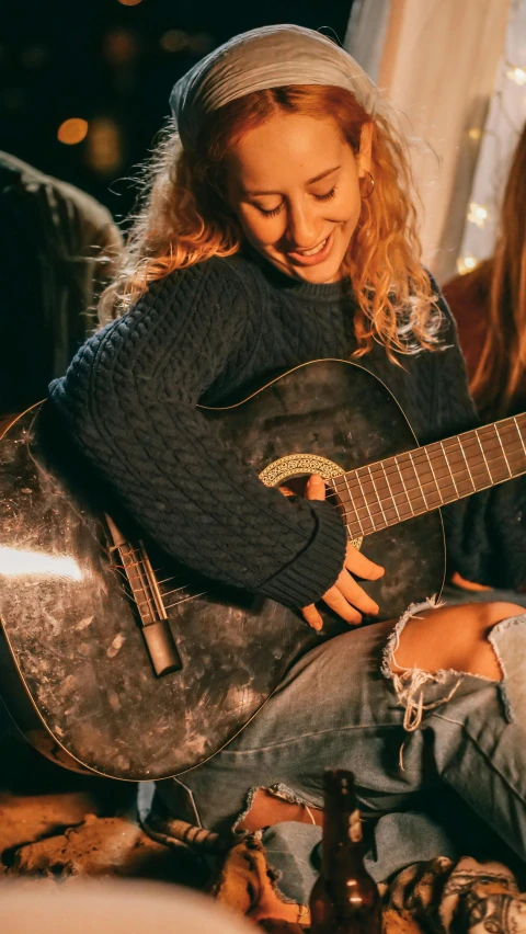 a couple of women sitting next to each other with a guitar, inspired by Anna Findlay, pexels contest winner, in a navy blue sweater, smiling down from above, profile image, female model