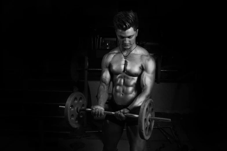 a man holding a barbell in the dark, a black and white photo, by Kristian Zahrtmann, pexels contest winner, [ adamantly defined abs ]!!, fantasy medium shot, monochrome hdr, gif