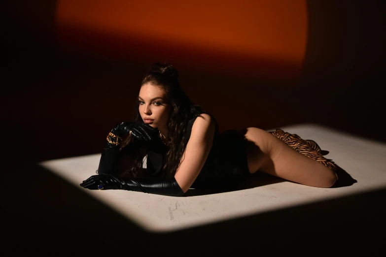a woman laying on top of a white surface, an album cover, renaissance, charli xcx, posing in dramatic lighting, portrait sophie mudd, scorpion