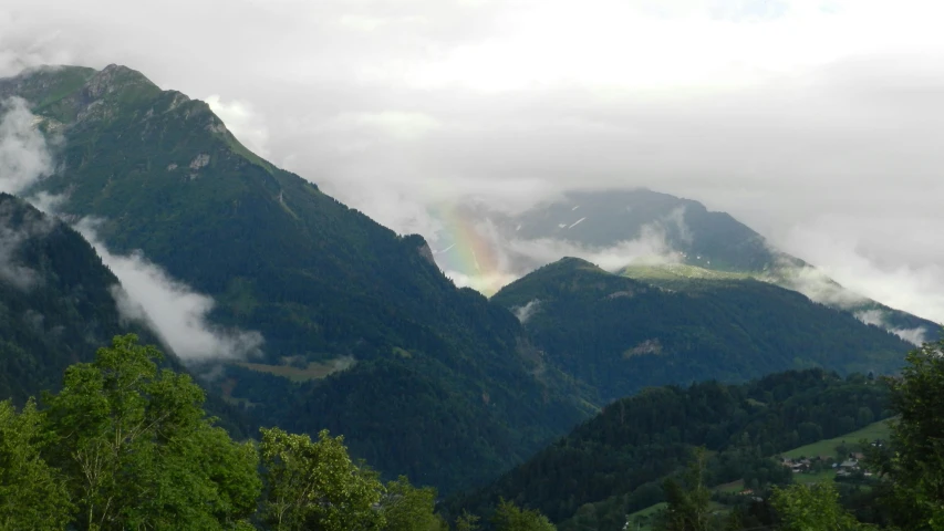 there is a rainbow in the sky over the mountains, a picture, by Breyten Breytenbach, les nabis, slide show, a green, alps, no cropping