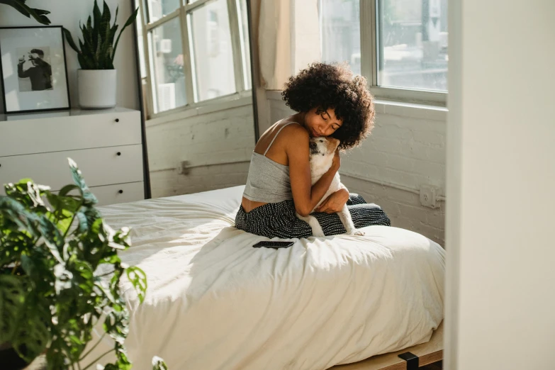 a woman sitting on a bed with a cat, trending on pexels, happening, beautiful city black woman only, sitting on the edge of a bed, supportive, natural lights