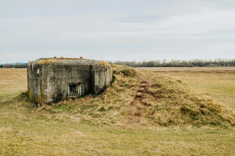 a concrete structure sitting in the middle of a field, a portrait, unsplash, eastern front, bunker, 1940s photo