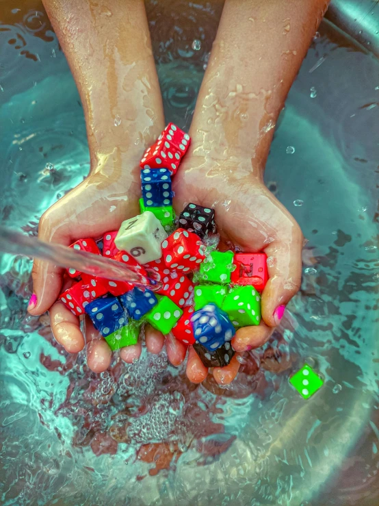 a person holding a bunch of dice in a bowl of water, profile image, pool tubes, hyper color photograph, square