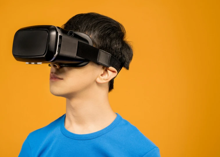 a man wearing a virtual reality headset against a yellow background, inspired by Goro Fujita, trending on pexels, teenage boy, looking into camera, schools, wide high angle view