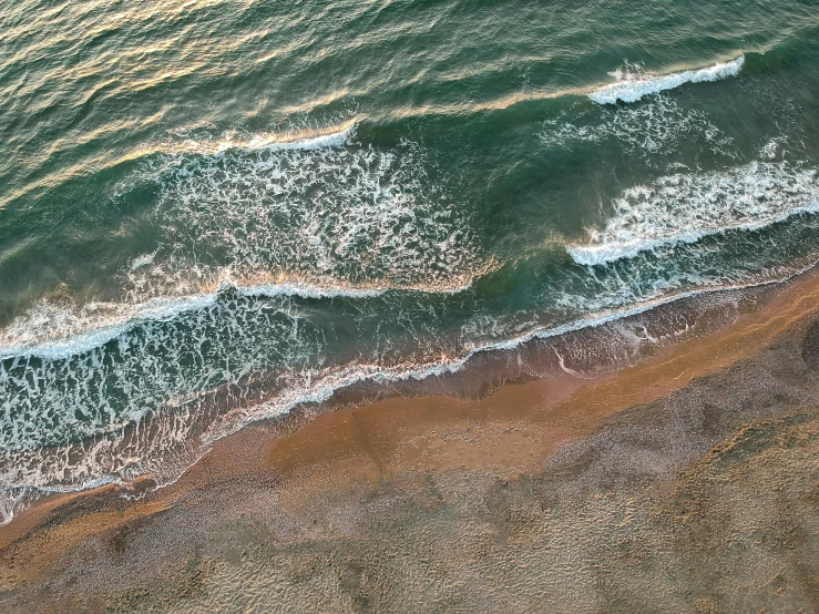 a person riding a surfboard on top of a sandy beach, pexels contest winner, renaissance, bird\'s eye view, early evening, deeply hyperdetailed, aerial view of an ancient land