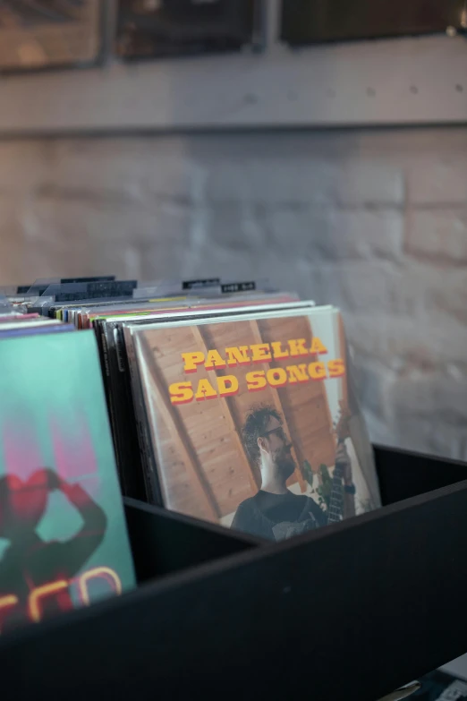 a pile of cd's sitting on top of a table, an album cover, pexels, shelf, panel of black, funkadelic, parallax »