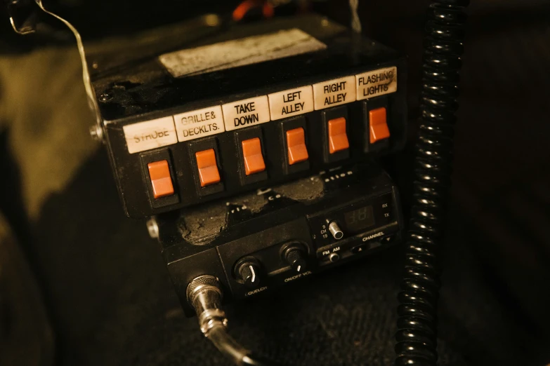 a close up of a radio on a table, black and orange colour palette, ghostbusters trap, emergency countermeasures, sirens