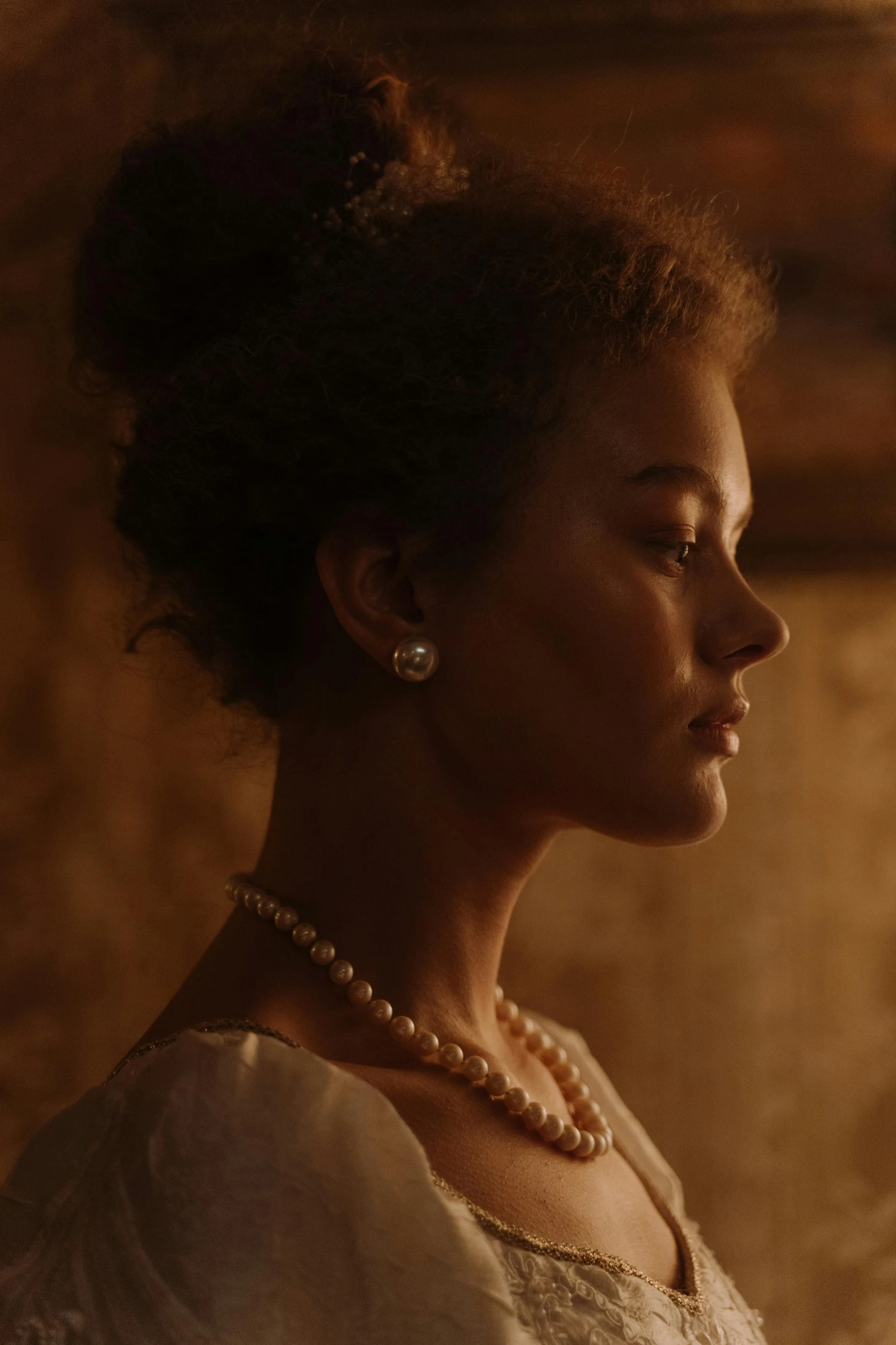 a woman in a white dress and pearls, inspired by Eliseu Visconti, pexels, renaissance, nathalie emmanuel, 4 k hd film still, [ theatrical ], warm glow