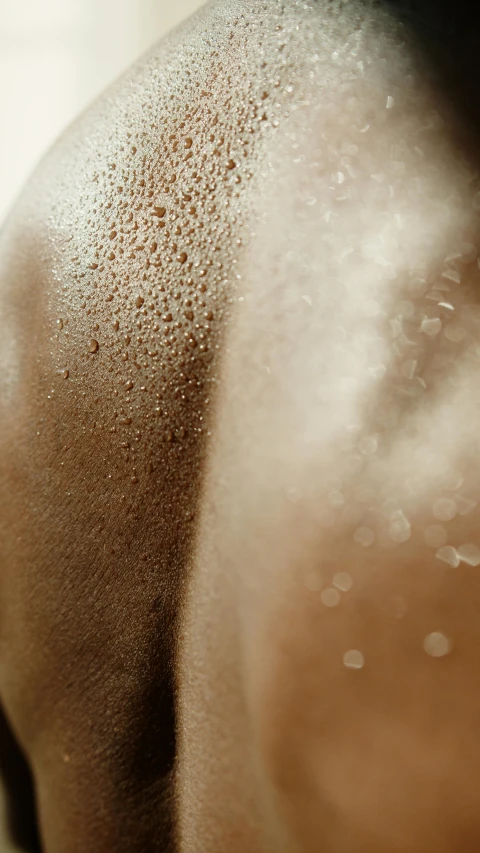 a close up of a person taking a shower, trending on pexels, conceptual art, light-brown skin, dust molecules, athletic muscle tone, toned derriere