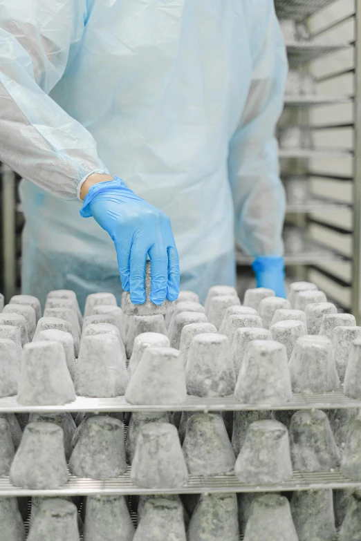 a person in a white lab coat and blue gloves, a marble sculpture, many cryogenic pods, premium quality, thumbnail, milk cubes