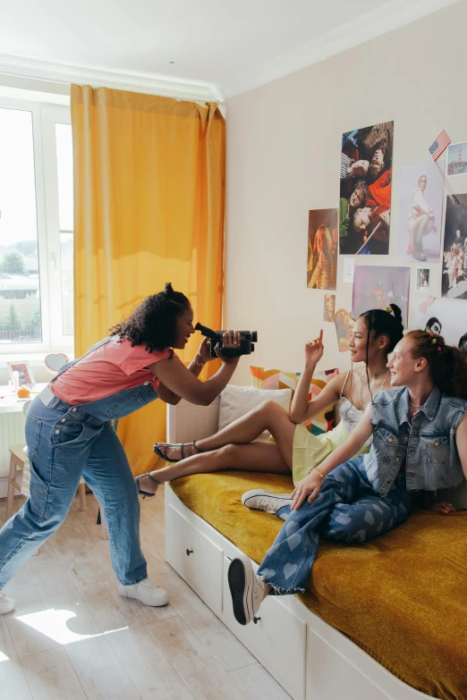 a group of people sitting on top of a bed, a picture, holding a camera, kids playing, shot with sony alpha, bella poarch