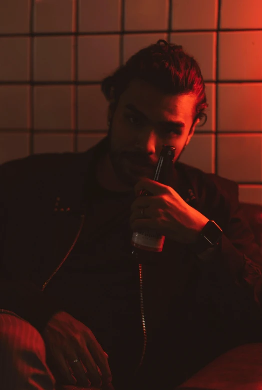 a man sitting on a couch smoking a cigarette, poster art, by Jacob Toorenvliet, pexels contest winner, red neon lights, jason momoa, man drinking beer, grainy low quality