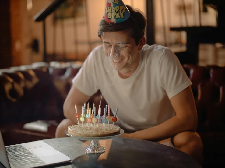 a man sitting at a table with a cake in front of him, pexels, happening, happy birthday candles, mark edward fischbach, gif, indoor picture