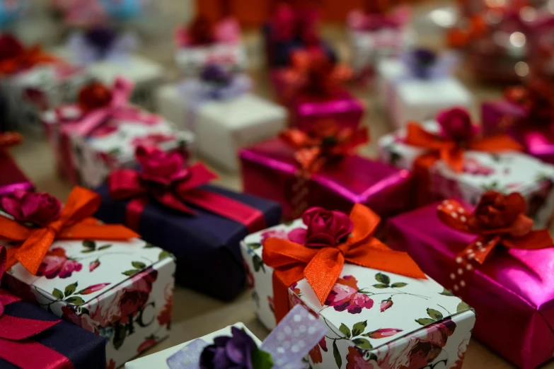 a bunch of gift boxes sitting on top of a table, by Alice Mason, pexels contest winner, happening, red and purple, many origami roses, bows, islamic