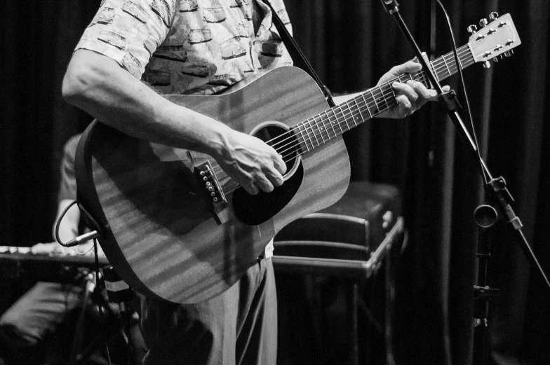 a man playing a guitar and singing into a microphone, by Neil Blevins, hands not visible, craig miller, musicians playing instruments, stanley kybric