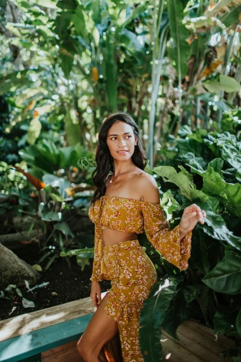 a woman standing next to a pool in a yellow dress, lush flora, wearing a crop top, in a jungle environment, wearing yellow floral blouse