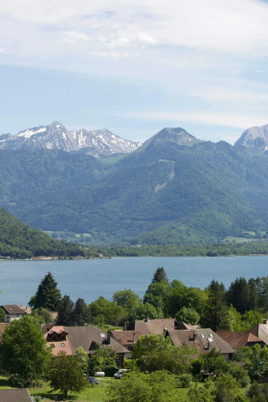 a view of a town with a lake and mountains in the background, grand majestic mountains, july 2 0 1 1, zoomed in shots, zenithal view