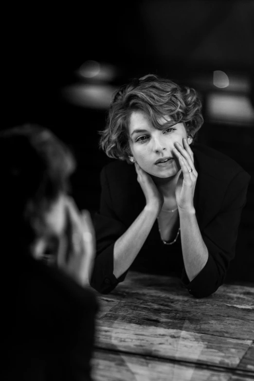 a woman sitting at a table talking on a cell phone, a black and white photo, inspired by Peter Lindbergh, unsplash contest winner, photorealism, milla jovovich, side portrait of imogen poots, 🤤 girl portrait, young sophia loren