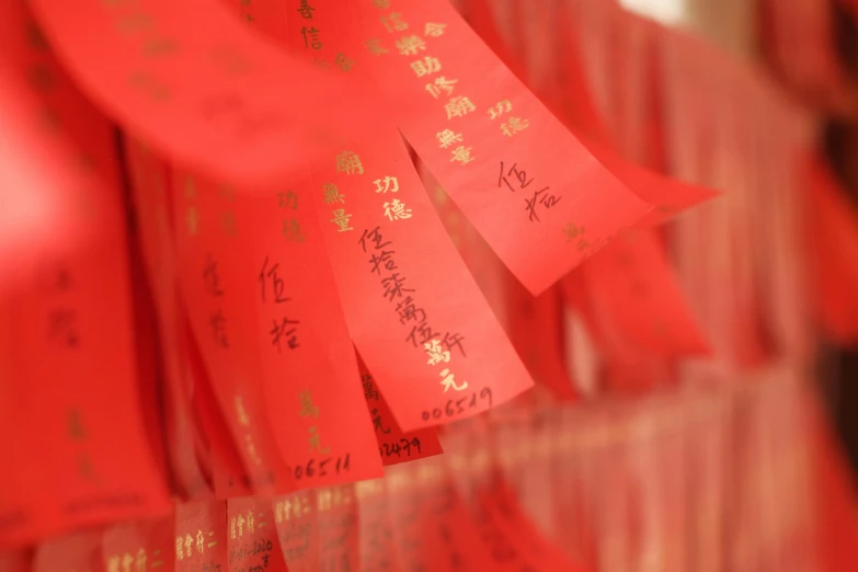 a bunch of red paper with chinese writing on it, a silk screen, pexels, satin ribbons, lots of light, in a row, delightful surroundings